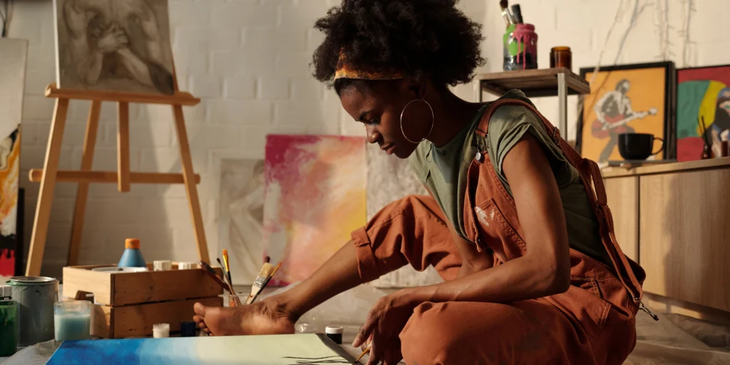 Artist painting in a creative studio space.