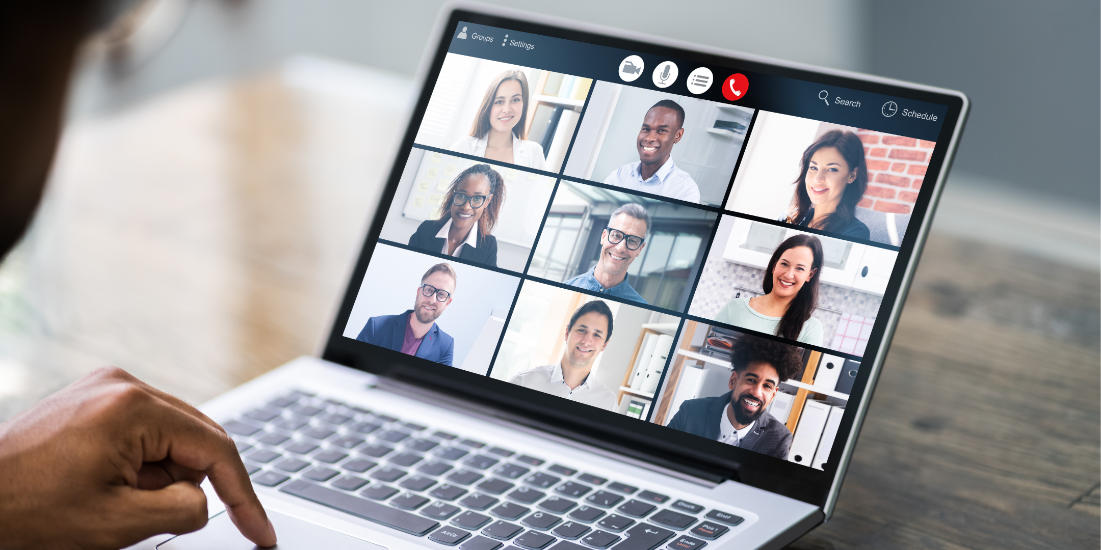 Laptop displaying a diverse group of people in a virtual video meeting, with a dark overlay and the word “Heading” centred on the image.
